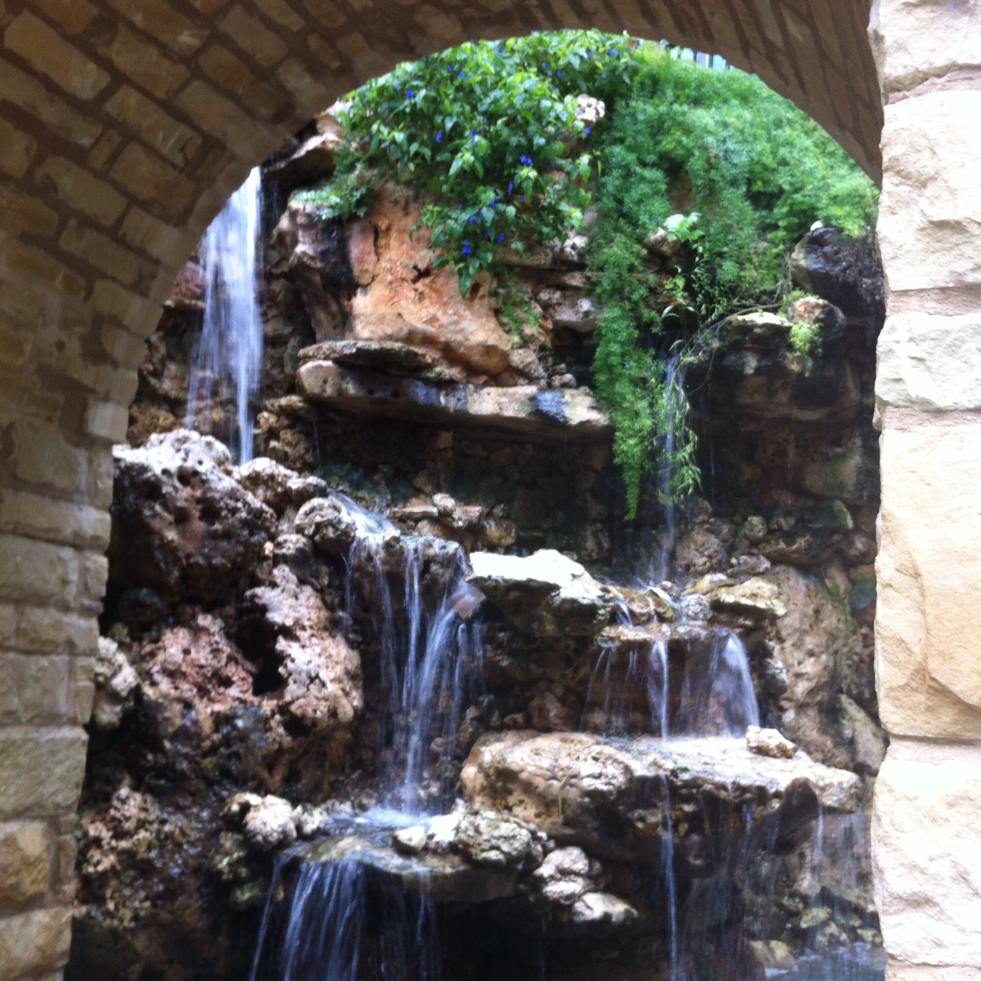 Archway with waterfall in the riverwalk in San Antonio while there for The Daring Way (TM) course